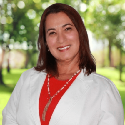 Idalmys Justi, dual-certified family and psychiatric nurse practitioner at Regions Praxis Care Corp, smiling in a professional outdoor portrait. Idalmys Justi, dual-certified family and psychiatric nurse practitioner at Regions Praxis Care Corp, smiling in a professional outdoor portrait.