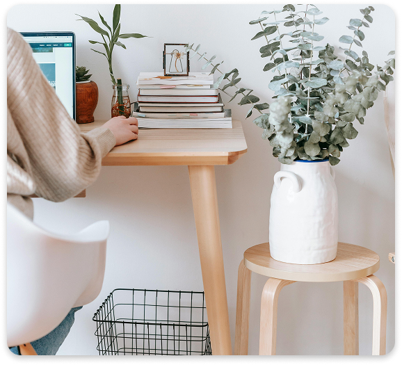 Secure and Comfortable Virtual Psychiatric Appointments Person attending a telehealth session from a cozy home office setup with a laptop and indoor plants.